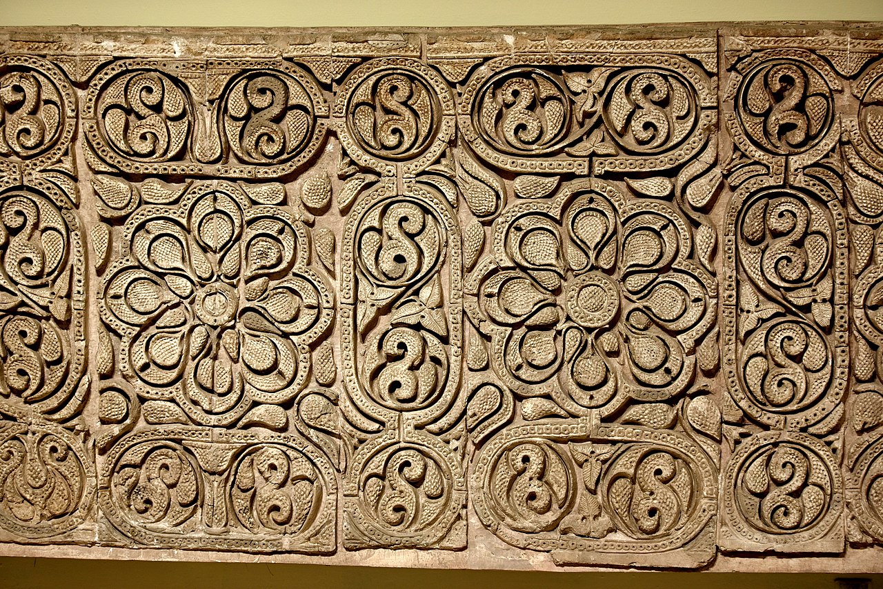 1280px-Carved_stucco_panel_from_Samarra,_3rd_century_AH,_Iraq_Museum.jpg